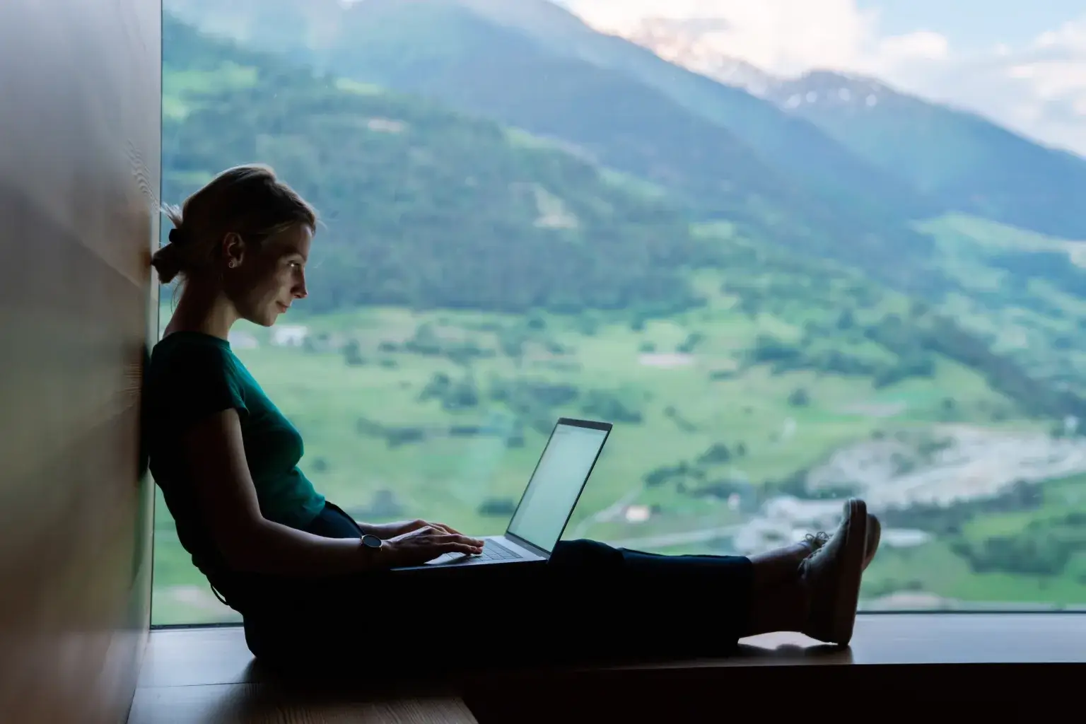 Skilled Caucasian female IT professional checking notification for laptop system connected to 4g internet, woman freelancer doing remote teleworking for banking via netbook app during vacations