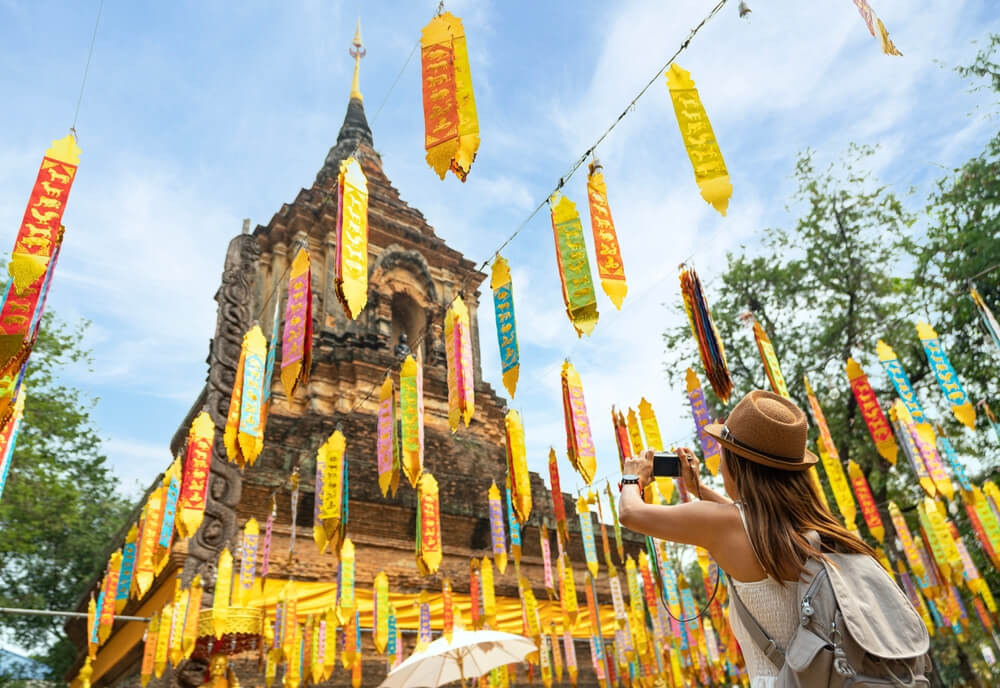 Asian traveller take a photo to Pagoda of wat lok moli temple in Chiang mai city, Thailand
