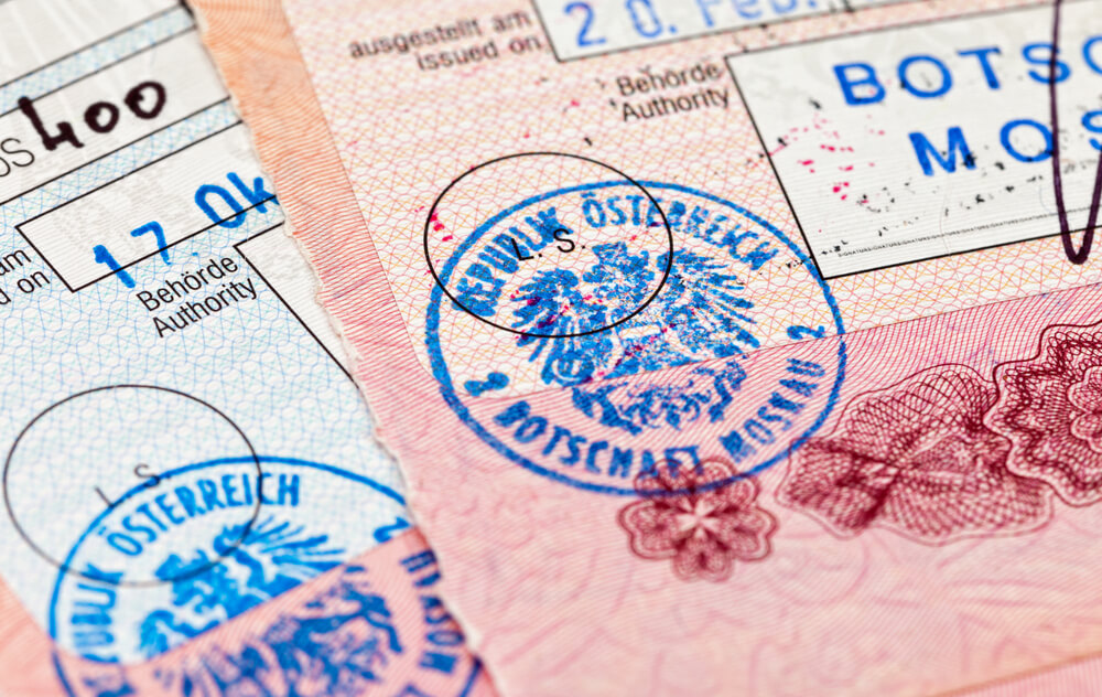Visa entry and exit stamps in passport
