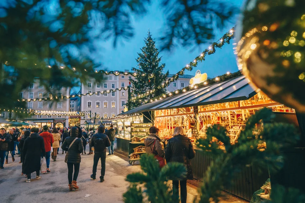 Salzburg, Austria Christmas Market seen trough a Christmas tree branches
