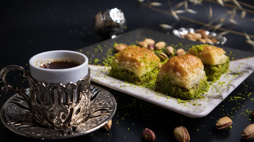 A pleasant break with pistachio baklava and Turkish coffee. Baklava with pistachios, one of the most popular flavors of Turkish cuisine. Combining the flavor of pistachios with Turkish coffee.
