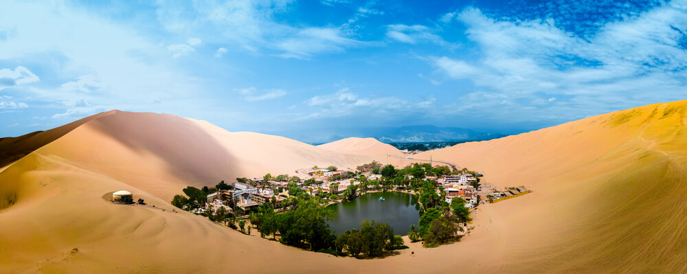 Oasis of Huacachina near Ica city in Peru. Lake and trees inside the dunes
