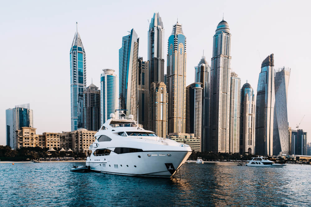 The yacht against the background of skyscrapers floats. Dubai
