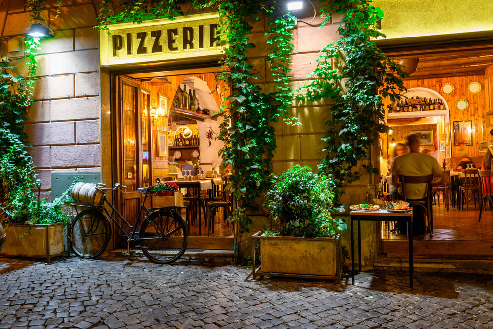 Old cozy street at night in Trastevere, Rome, Italy. Trastevere is rione of Rome, on the west bank of the Tiber in Rome, Lazio, Italy. Architecture and landmark of Rome.
