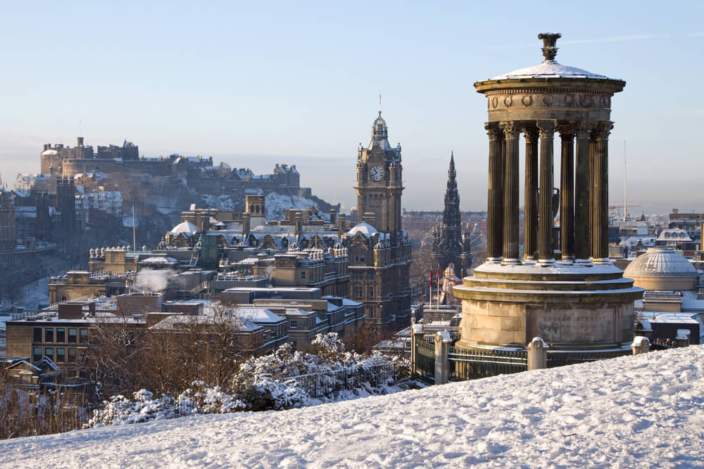 Edinburgh City and Castle, Scotland, captured from Calton Hill on a bright winter day with the Dugald Stewart monument in the foreground, the Scott monument and Balmoral clock tower in the background.
