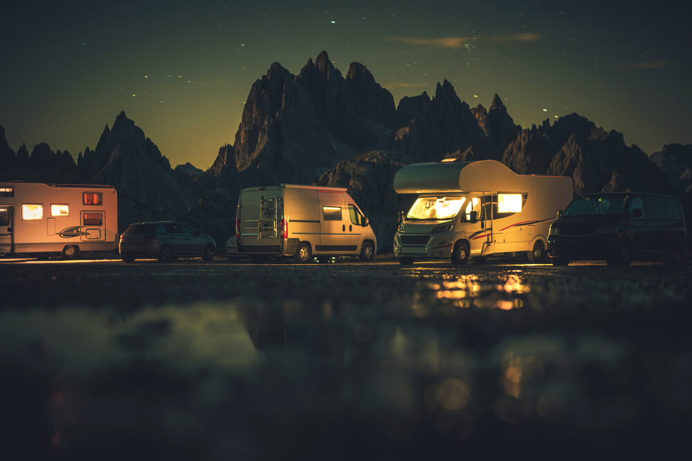 Summer Vacation and Road Trip in Motorhome. Recreational Vehicles RVs Overnight Alpine Camping. Dolomites Misurina, Italy.
