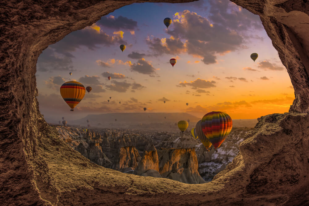 Goreme, Cappadocia, Beautiful scenes in Goreme national park. Hundreds of colorful hot air balloons flying in the sky on sunrise. Incredible rock formations in motorhome parking in turkey the valley
