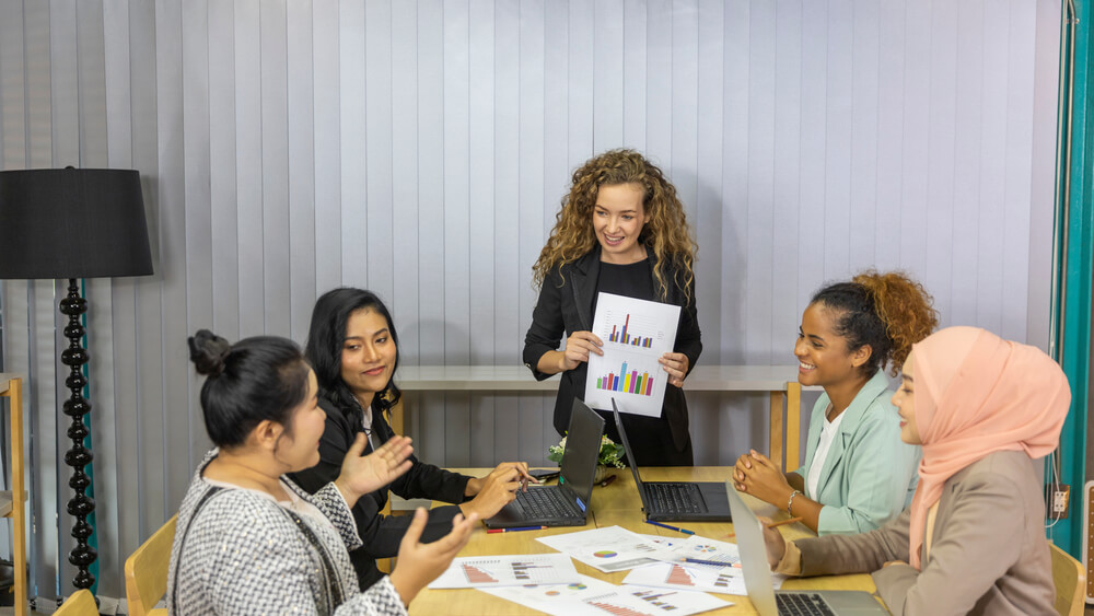 Business women from different ethnic races and cultures working together in an office for business development or plan
