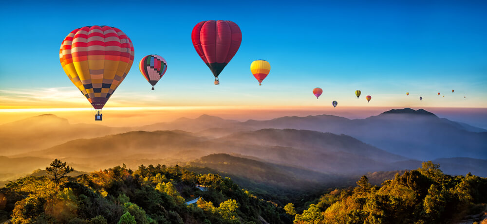 Colorful hot air balloons flying over mountain at Dot Inthanon in Chiang Mai, Thailand.
