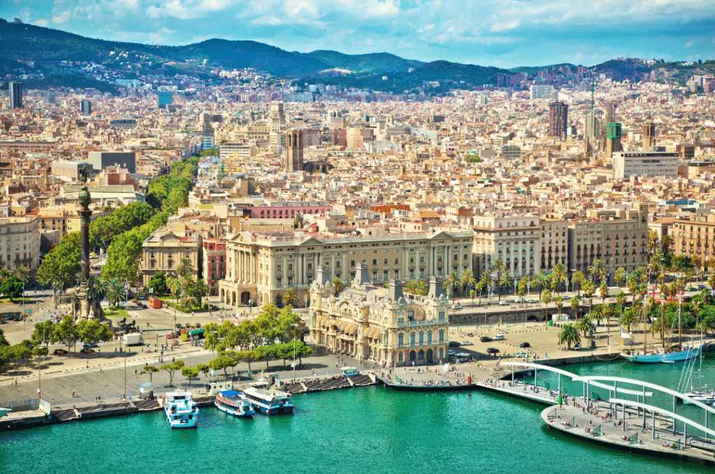 Aerial view of Barcelona waterfront and Columbus Monument on a sunny summer day – top Spain destination for beach travel and historic cityscapes.