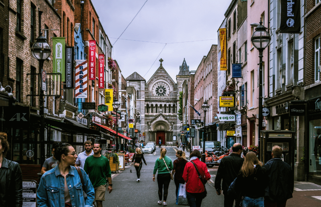 Busy pedestrians walking down Grafton Street in Dublin, Ireland – known for its friendly locals and cultural charm