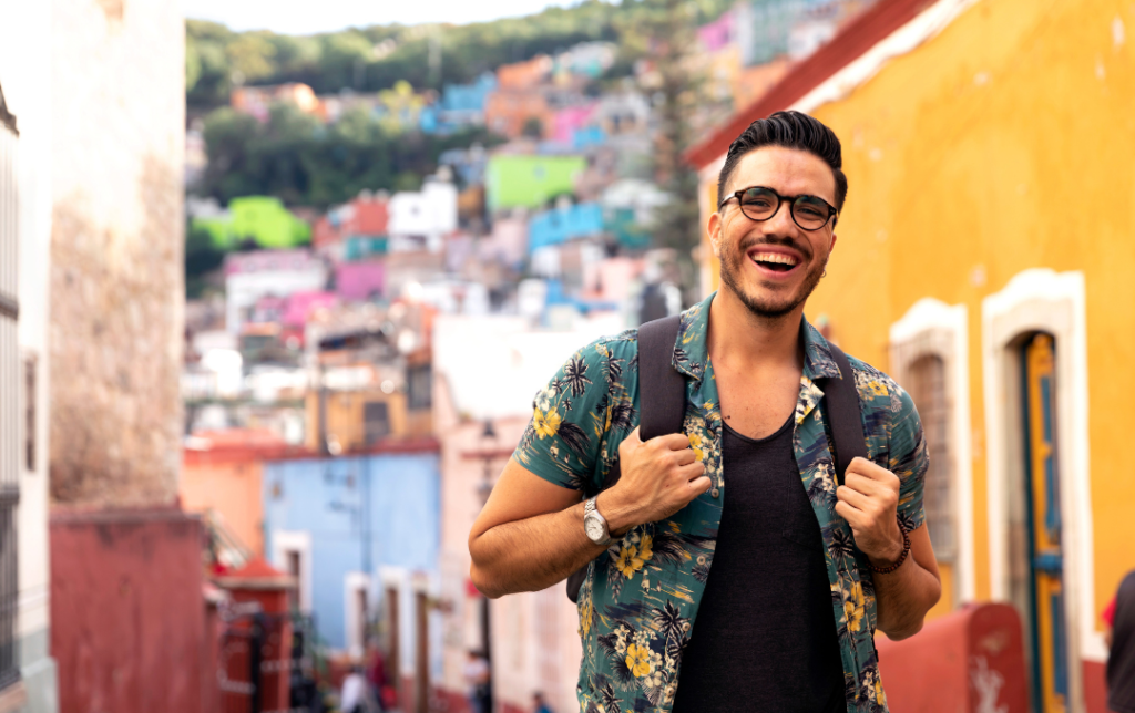 a digital nomad smiling at the camera while traveling