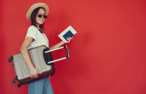 a digital nomad with her suitcase and passport getting ready for travel tuesday