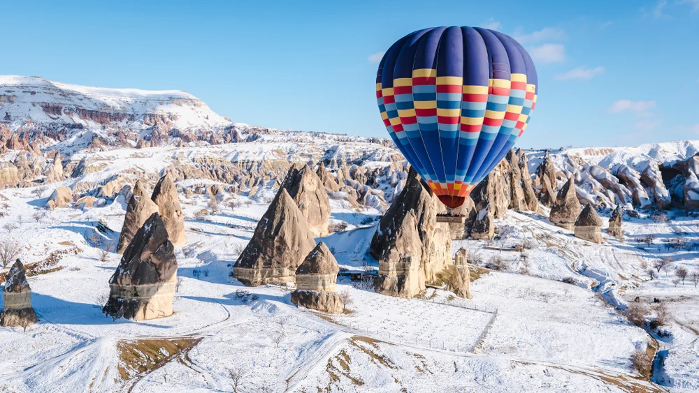 Colorful hot air balloons flying over mountain at Cappadocia, Turkey
